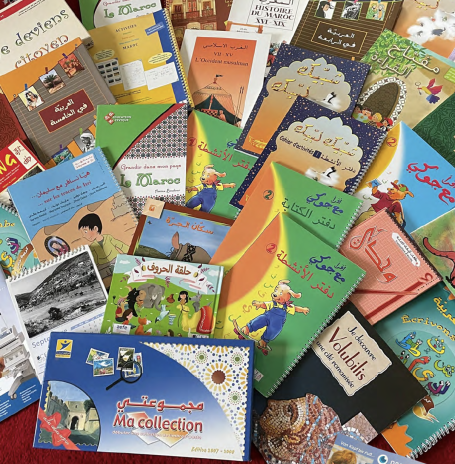 Schulbücher Verschiedene farbige Kinderbücher aus verschiedenen Genres auf einem Tisch verteilt.